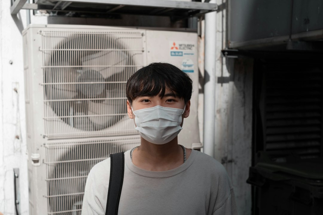 Technician performing air-conditioning service for an AC repair cost guide