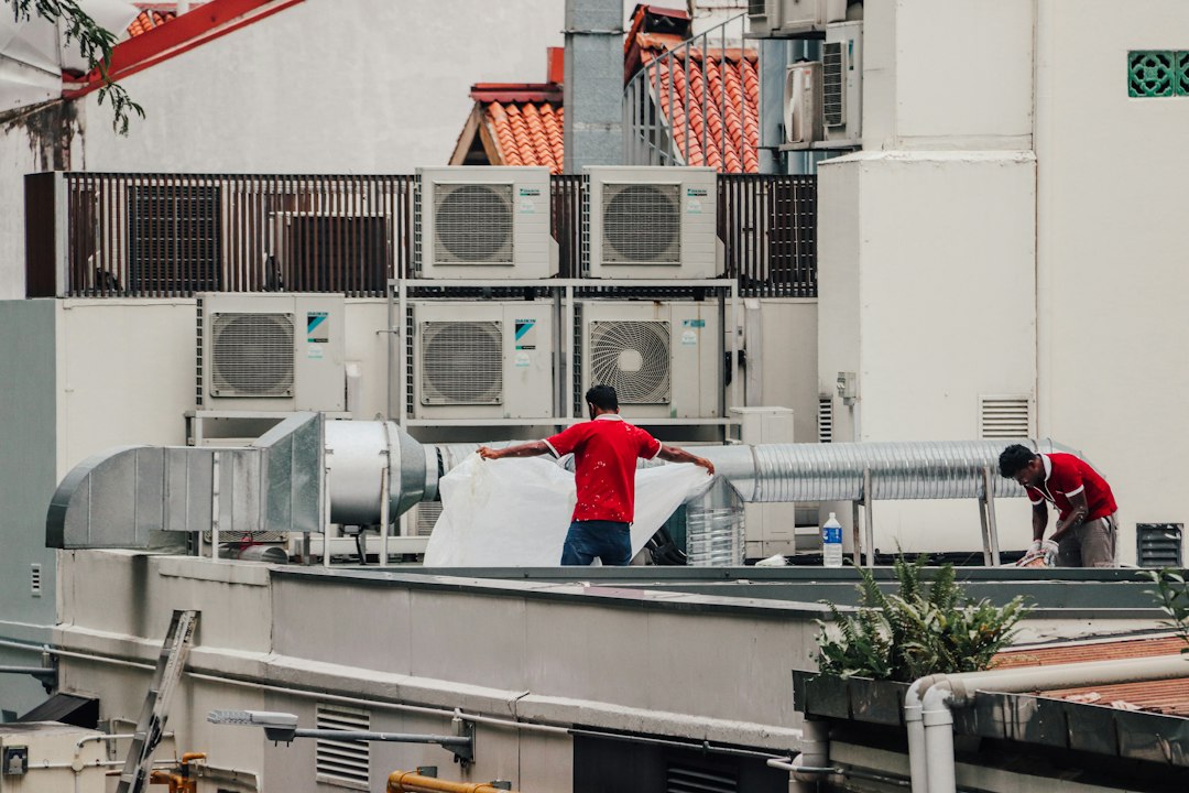 Technician working on cooling equipment for an HVAC repair cost guide