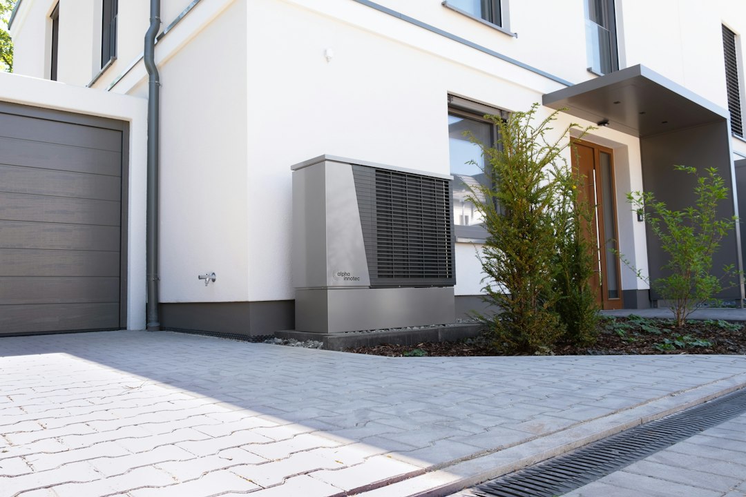 Residential heat pump beside a modern home for a heat pump replacement cost guide